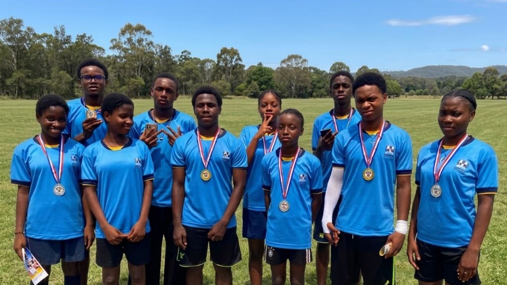 Medal presentation at Sanctum Games with branded school backdrop